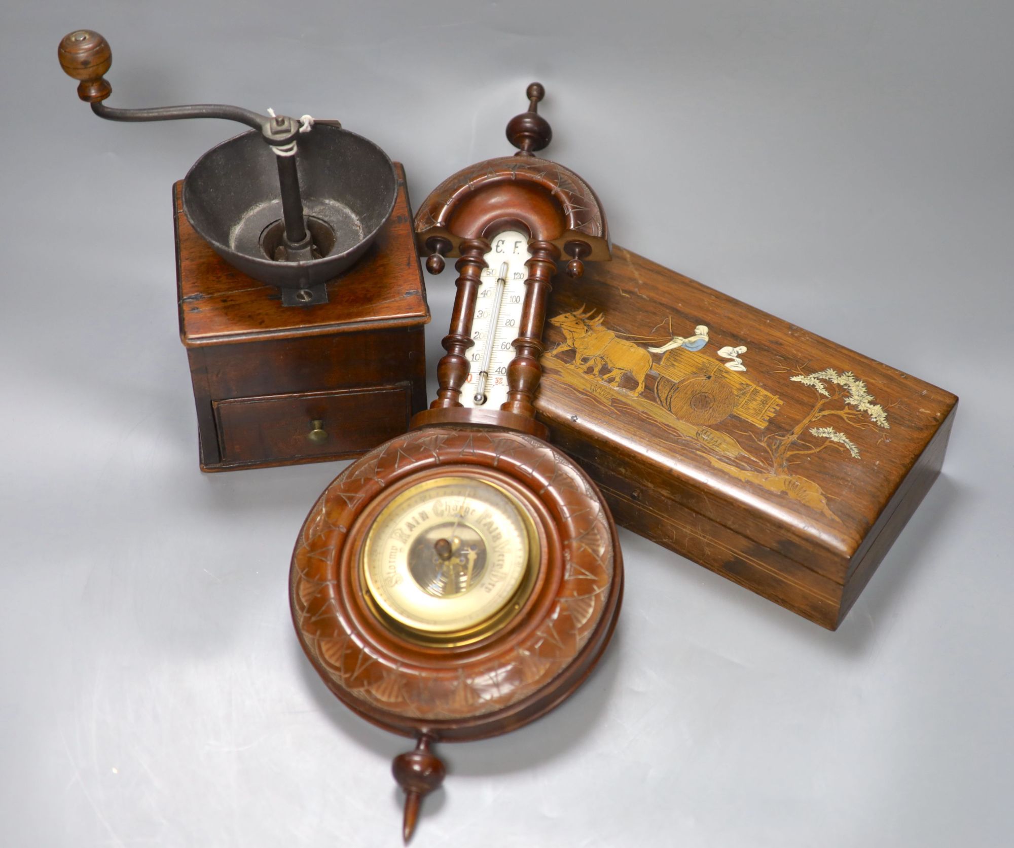 An aneroid barometer together with a 19th century mahogany coffee grinder and an inlaid box